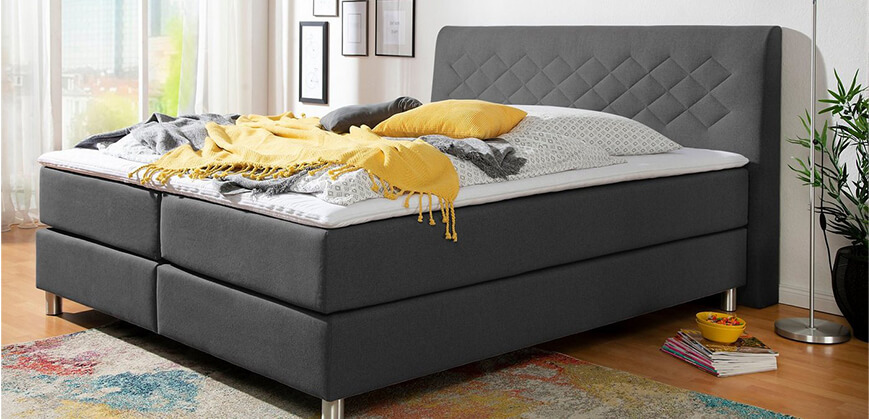 Grijze boxspring Grijze boxspring met bedlinnen